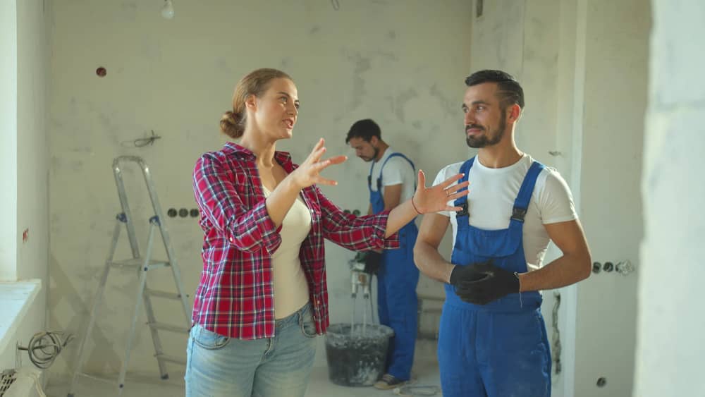 Woman talks about repair to a builder