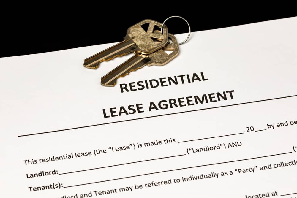 Residential lease agreement contract and keys. Home ownership, rental, and housing market concept.