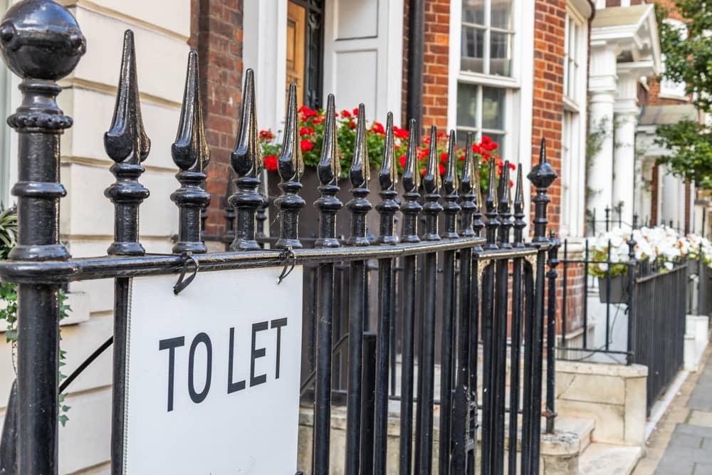 London townhouse with To Let sign on wrought iron railings, rental property market street