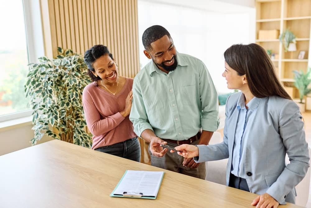 Female Real Estate Agent Selling Modern Apartment To His Young Clients , the  couple signing agreement contract  In The Fancy Apartment