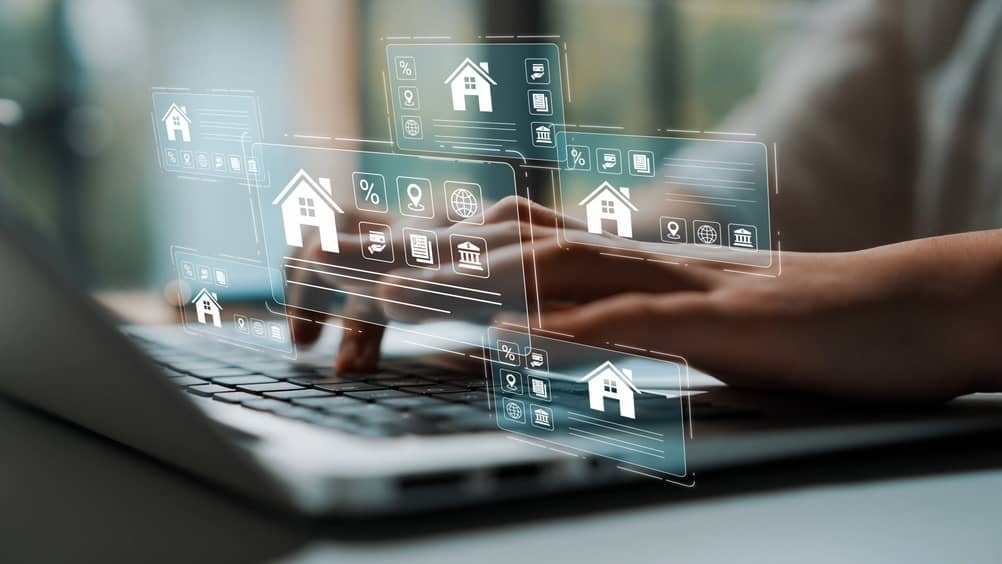 Digital interaction with real estate icons on a laptop, showcasing modern technology and online property search concepts for buyers and sellers. Gluon.