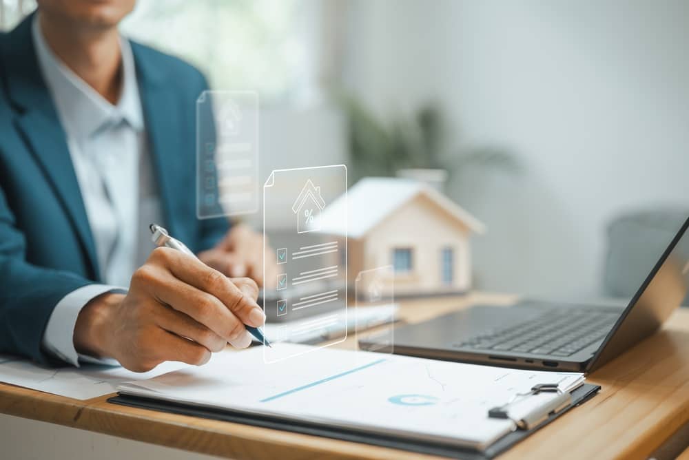 Real estate professional reviewing property management documents with digital checklist and housing data, representing investment planning, asset management, and property administration.