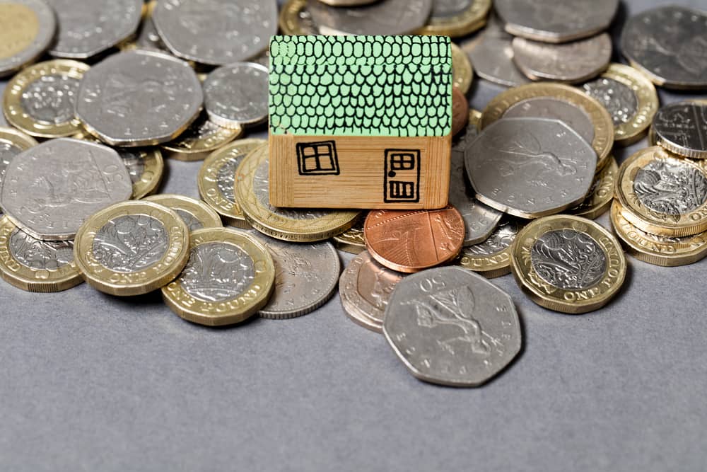 House model with british coins. Home finance concept
